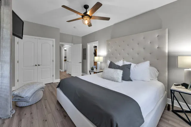 a bedroom with a bed and a chandelier