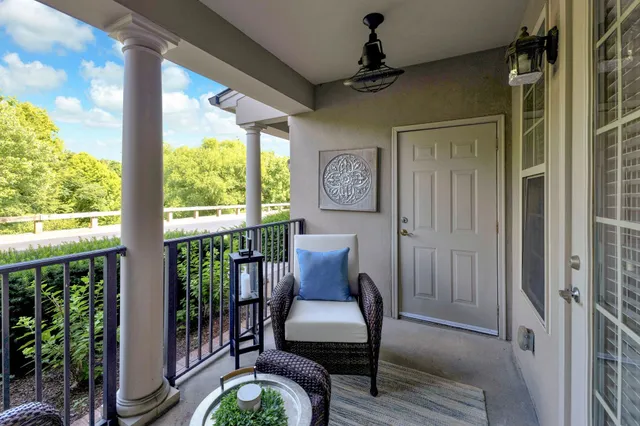 a balcony with furniture and wooden floor