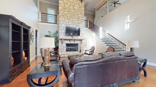a living room with furniture a flat screen tv and a fireplace