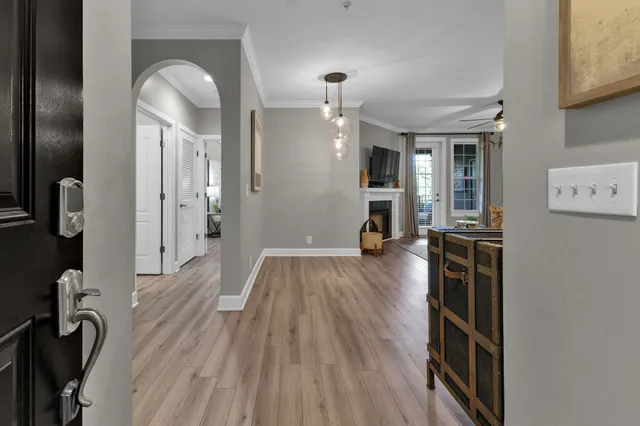 a view of a hallway with wooden floor and staircase