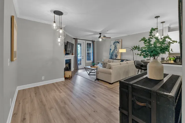 a living room with furniture and a wooden floor