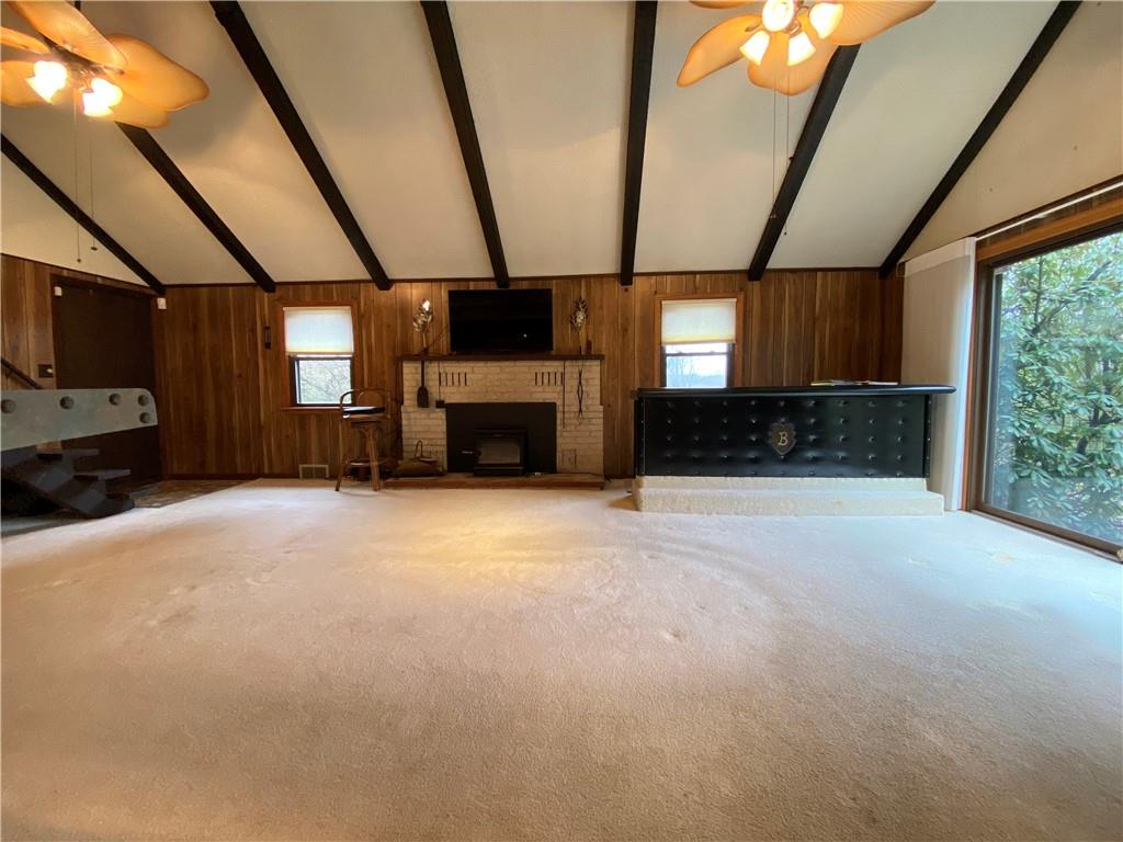 692 Mitchell Hill Road Greenville, PA 16125 - Photo 24 of 49 a living room with furniture a flat screen tv and a fireplace
