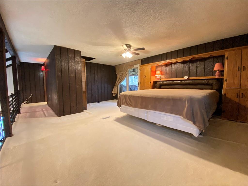 692 Mitchell Hill Road Greenville, PA 16125 - Photo 34 of 49 a bedroom with a large bed and a chandelier