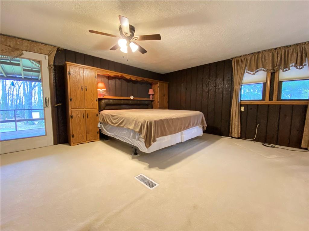 692 Mitchell Hill Road Greenville, PA 16125 - Photo 35 of 49 a spacious bedroom with a bed and dresser with wooden floor