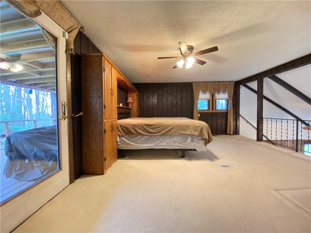 692 Mitchell Hill Road Greenville, PA 16125 - Photo 36 of 49 a bedroom with a large bed and a chandelier