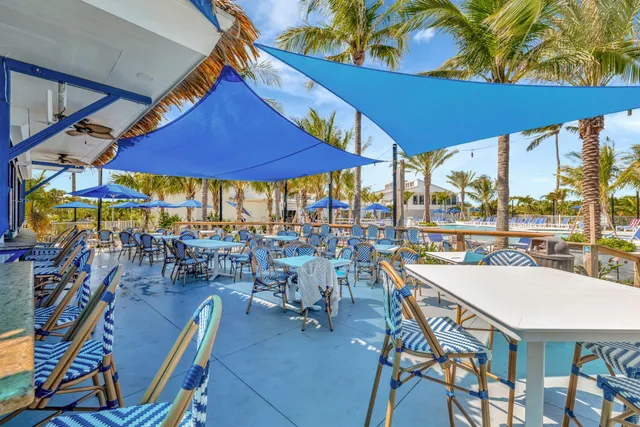 a view of a patio with table and chairs under an umbrella