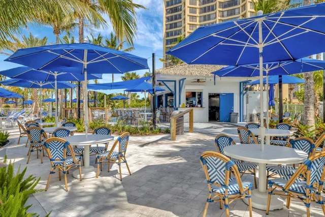 a patio with a table and chairs under an umbrella