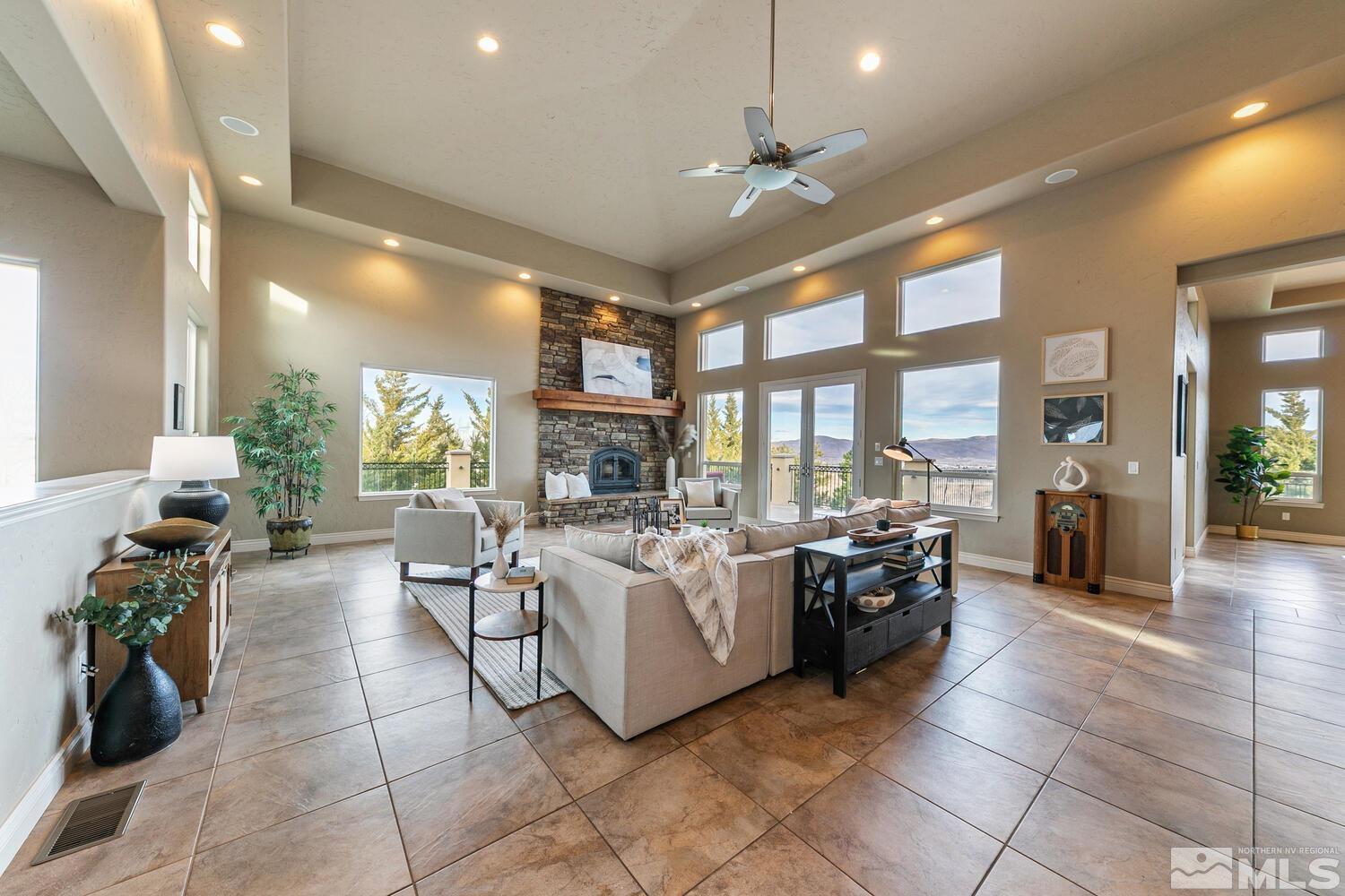 220 Brunswick Mill Road Reno, NV 89511 - Photo 13 of 39 a living room with furniture a large window and a chandelier