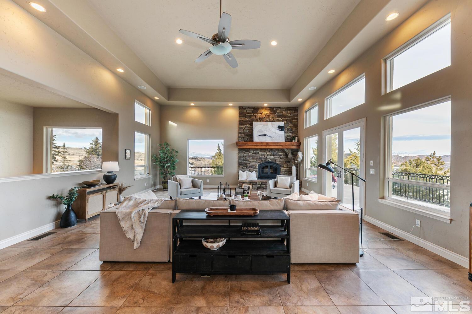 220 Brunswick Mill Road Reno, NV 89511 - Photo 14 of 39 a living room with couches a fireplace kitchen view and a large window