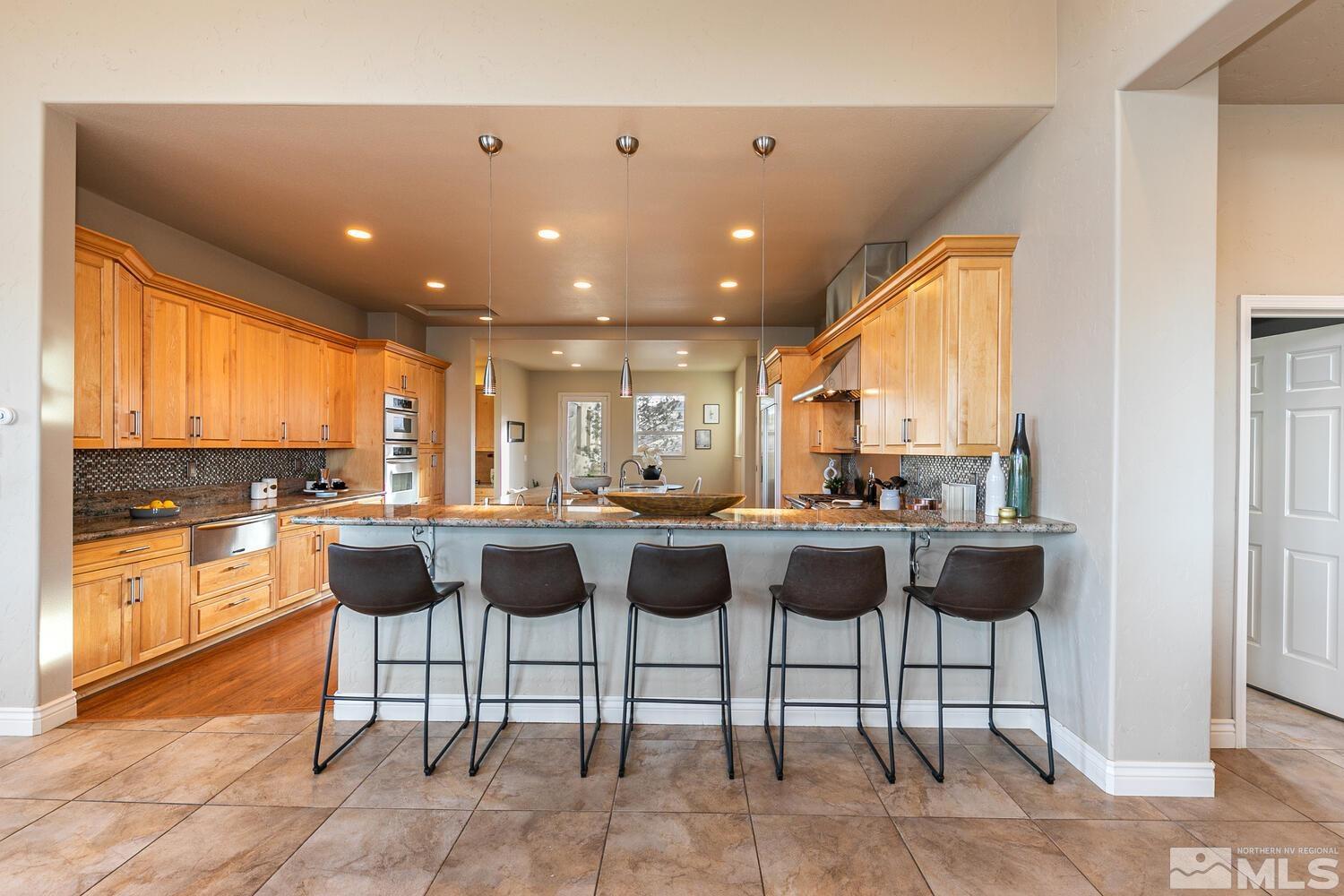 220 Brunswick Mill Road Reno, NV 89511 - Photo 15 of 39 a view of a dining room with a table and chairs
