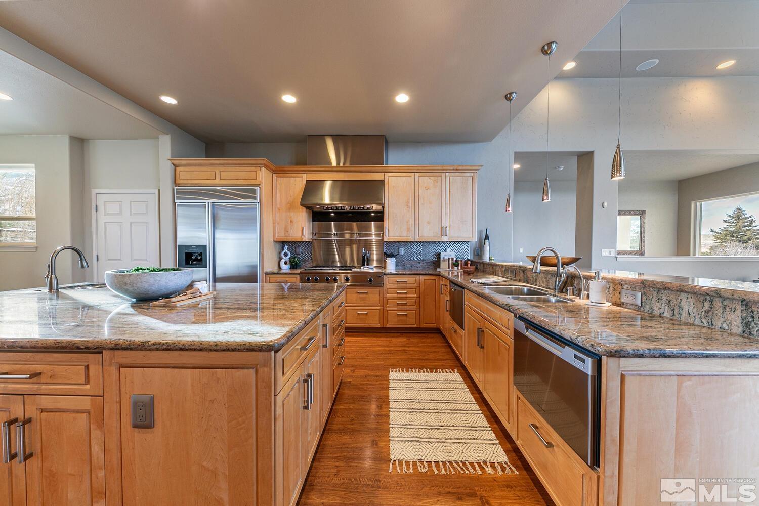 220 Brunswick Mill Road Reno, NV 89511 - Photo 16 of 39 a large kitchen with stainless steel appliances granite countertop a sink counter space and a sink