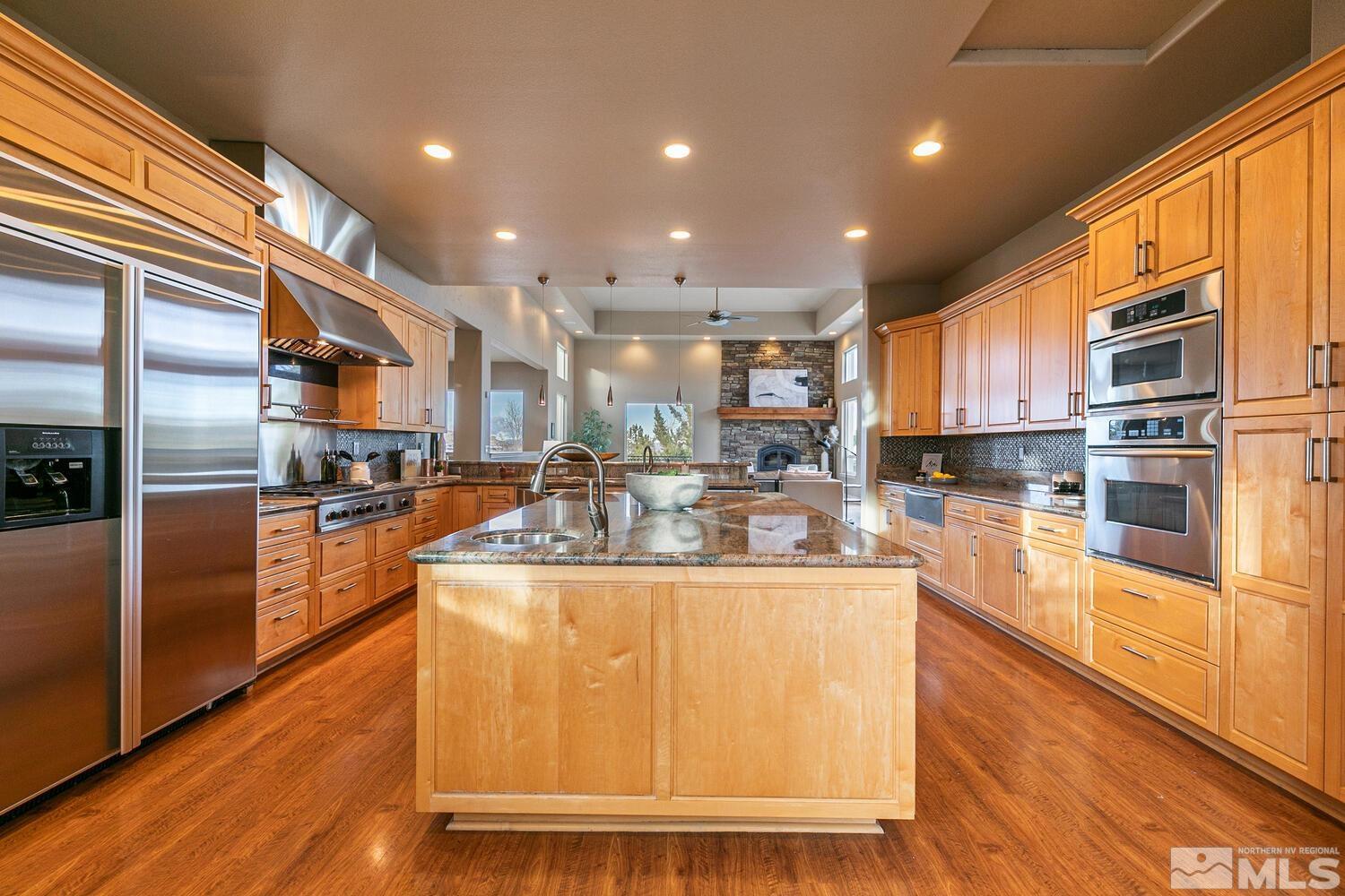 220 Brunswick Mill Road Reno, NV 89511 - Photo 17 of 39 a kitchen with stainless steel appliances granite countertop a refrigerator a stove top oven and a sink