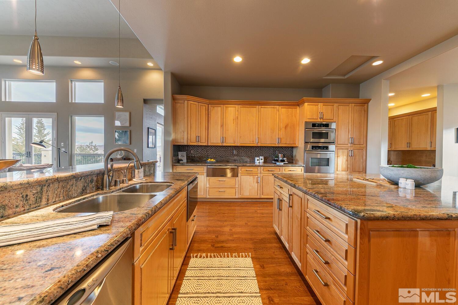 220 Brunswick Mill Road Reno, NV 89511 - Photo 19 of 39 a large kitchen with stainless steel appliances granite countertop a sink and cabinets