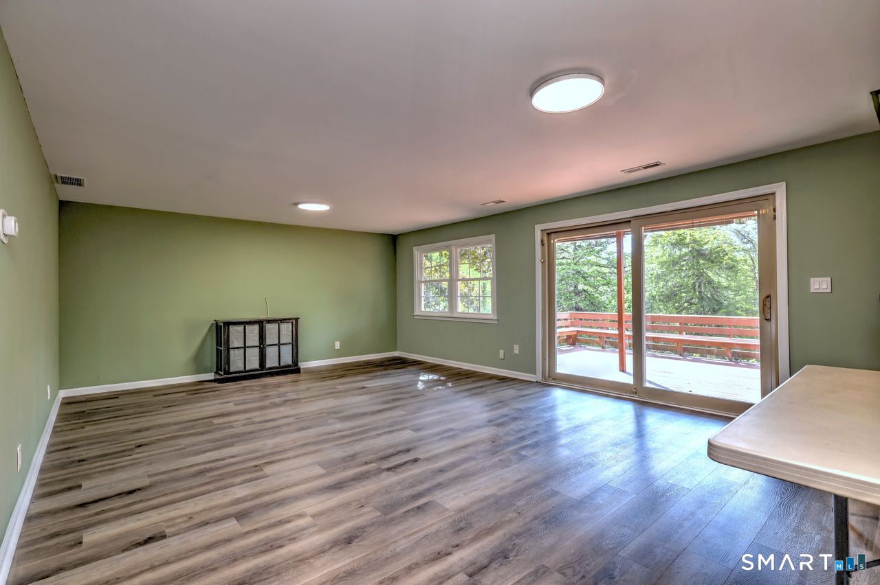 90 Brook Hill Road Hamden, CT 06514 - Photo 11 of 36 a view of an empty room with wooden floor and a window