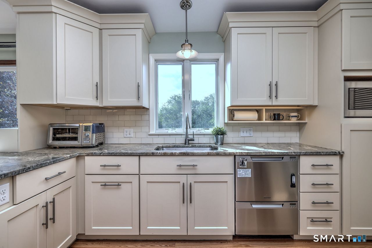 90 Brook Hill Road Hamden, CT 06514 - Photo 19 of 36 a kitchen with granite countertop white cabinets and white appliances