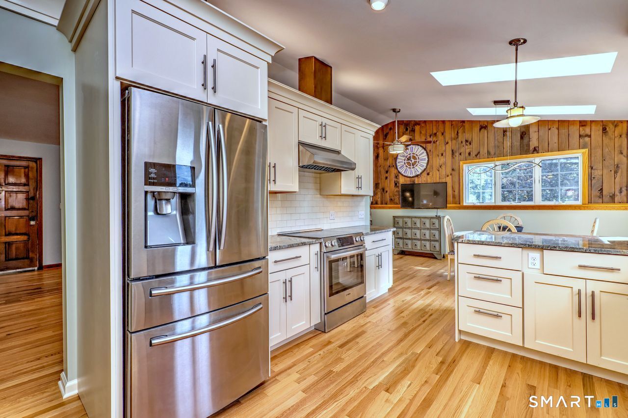 90 Brook Hill Road Hamden, CT 06514 - Photo 21 of 36 a kitchen with stainless steel appliances granite countertop a refrigerator and a stove top oven