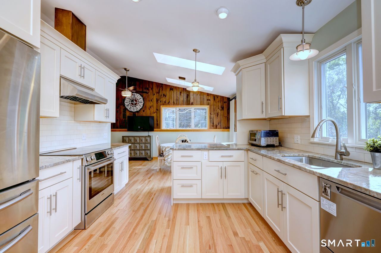 90 Brook Hill Road Hamden, CT 06514 - Photo 22 of 36 a kitchen with stainless steel appliances a stove sink and cabinets