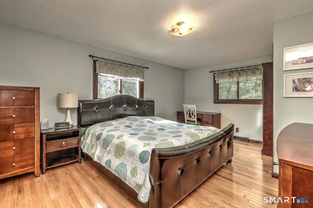 90 Brook Hill Road Hamden, CT 06514 - Photo 25 of 36 Primary bedroom with full bath and walk in closet, hardwood floor