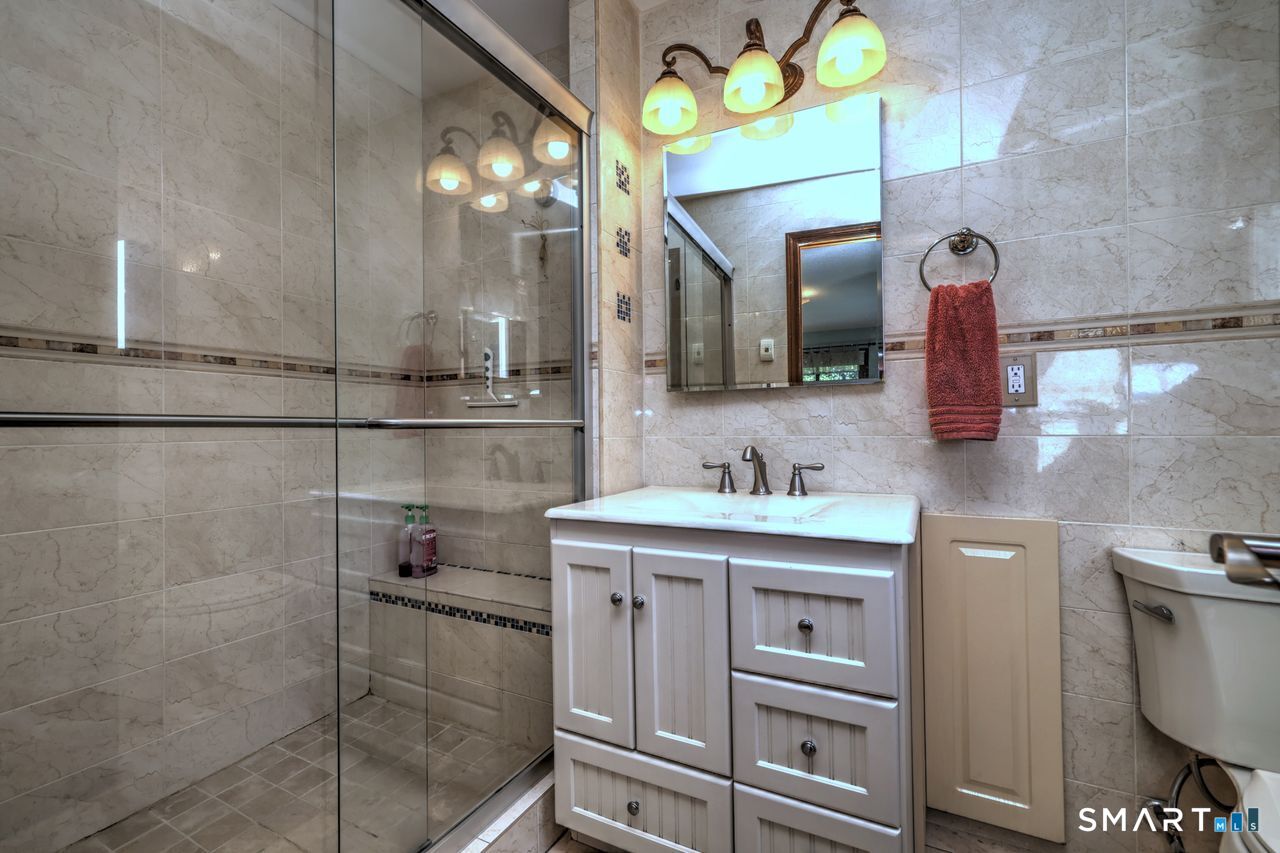 90 Brook Hill Road Hamden, CT 06514 - Photo 25 of 36 a bathroom with a sink vanity and mirror