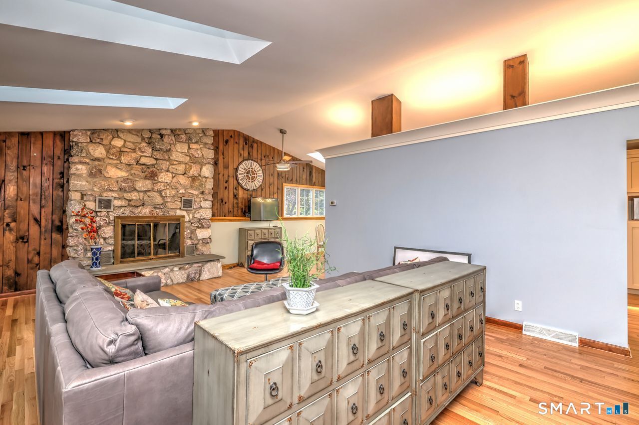 90 Brook Hill Road Hamden, CT 06514 - Photo 7 of 36 Living room with fire place, hardwood floor and skylight