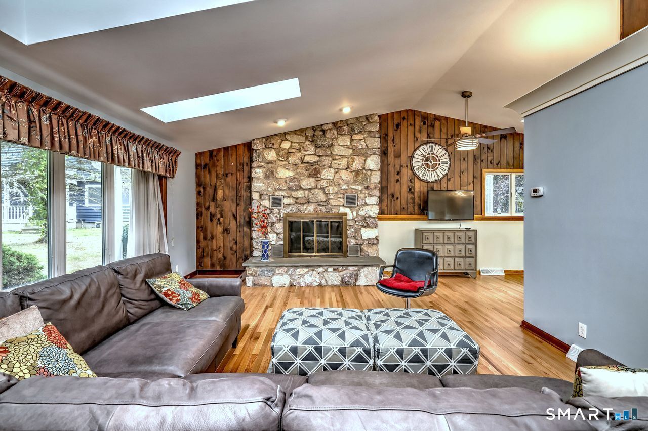 90 Brook Hill Road Hamden, CT 06514 - Photo 8 of 36 Living room with fire place, hardwood floor and skylight