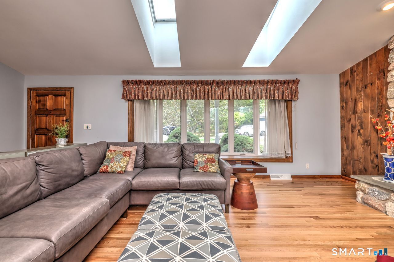 90 Brook Hill Road Hamden, CT 06514 - Photo 10 of 36 Living room with fire place, hardwood floor and skylight