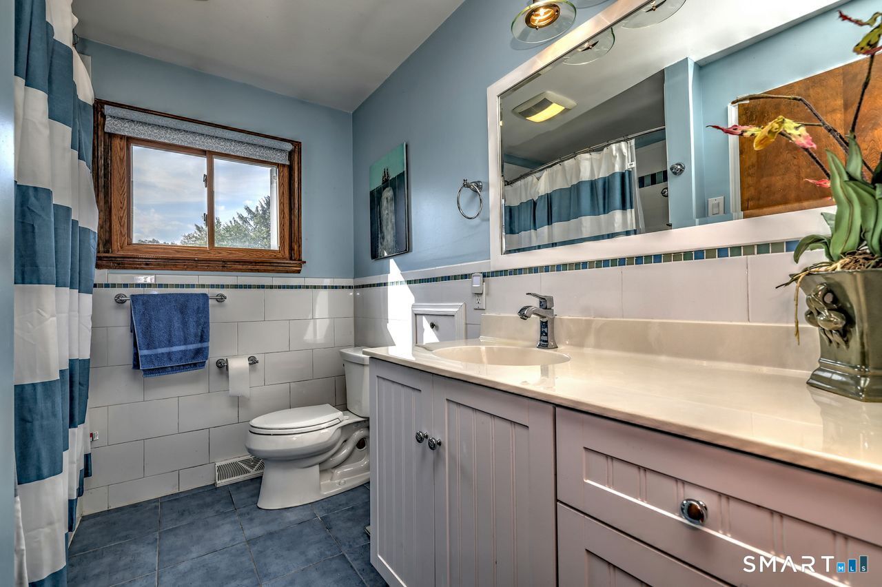 90 Brook Hill Road Hamden, CT 06514 - Photo 10 of 36 a bathroom with a toilet a sink and mirror