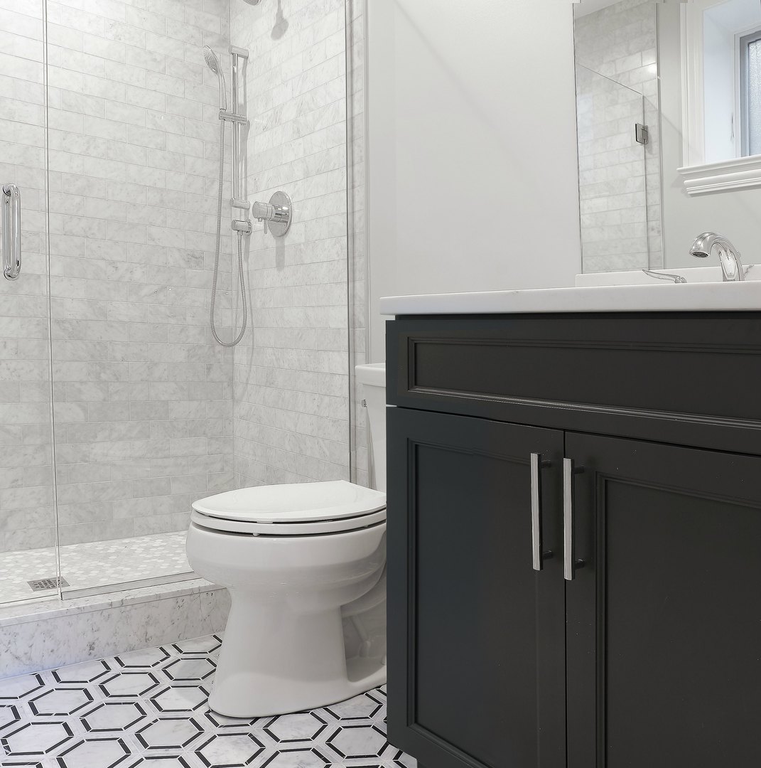 733 West Melrose Street, Unit 2 Chicago, IL 60657 - Photo 12 of 18 a bathroom with a sink a toilet and shower