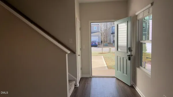 a kitchen with stainless steel appliances granite countertop a refrigerator sink and white cabinets