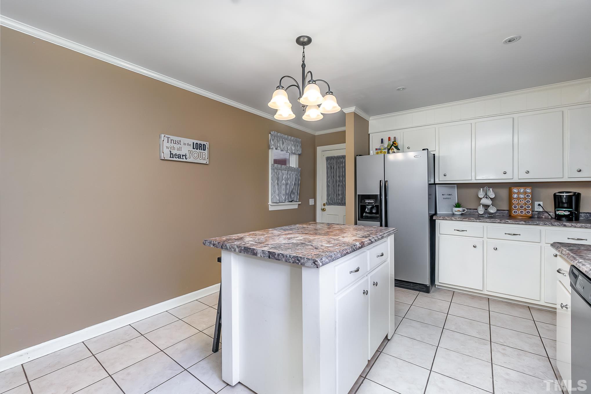 2904 Hodges Road Kinston, NC 28504 - Photo 12 of 29 a kitchen with granite countertop cabinets a refrigerator and a stove top oven