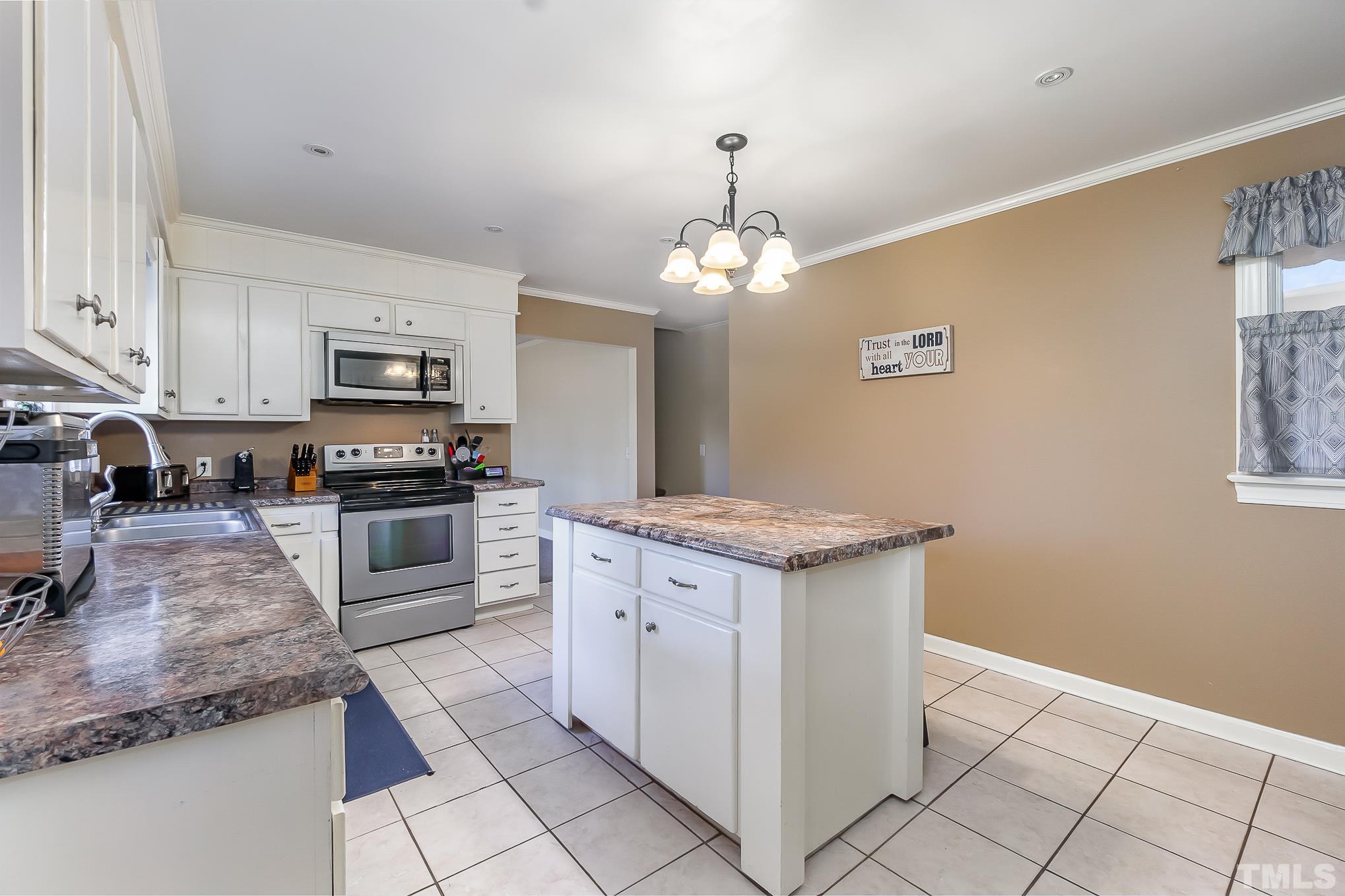 2904 Hodges Road Kinston, NC 28504 - Photo 13 of 29 a kitchen with stainless steel appliances granite countertop a stove top oven a sink a counter space and cabinets