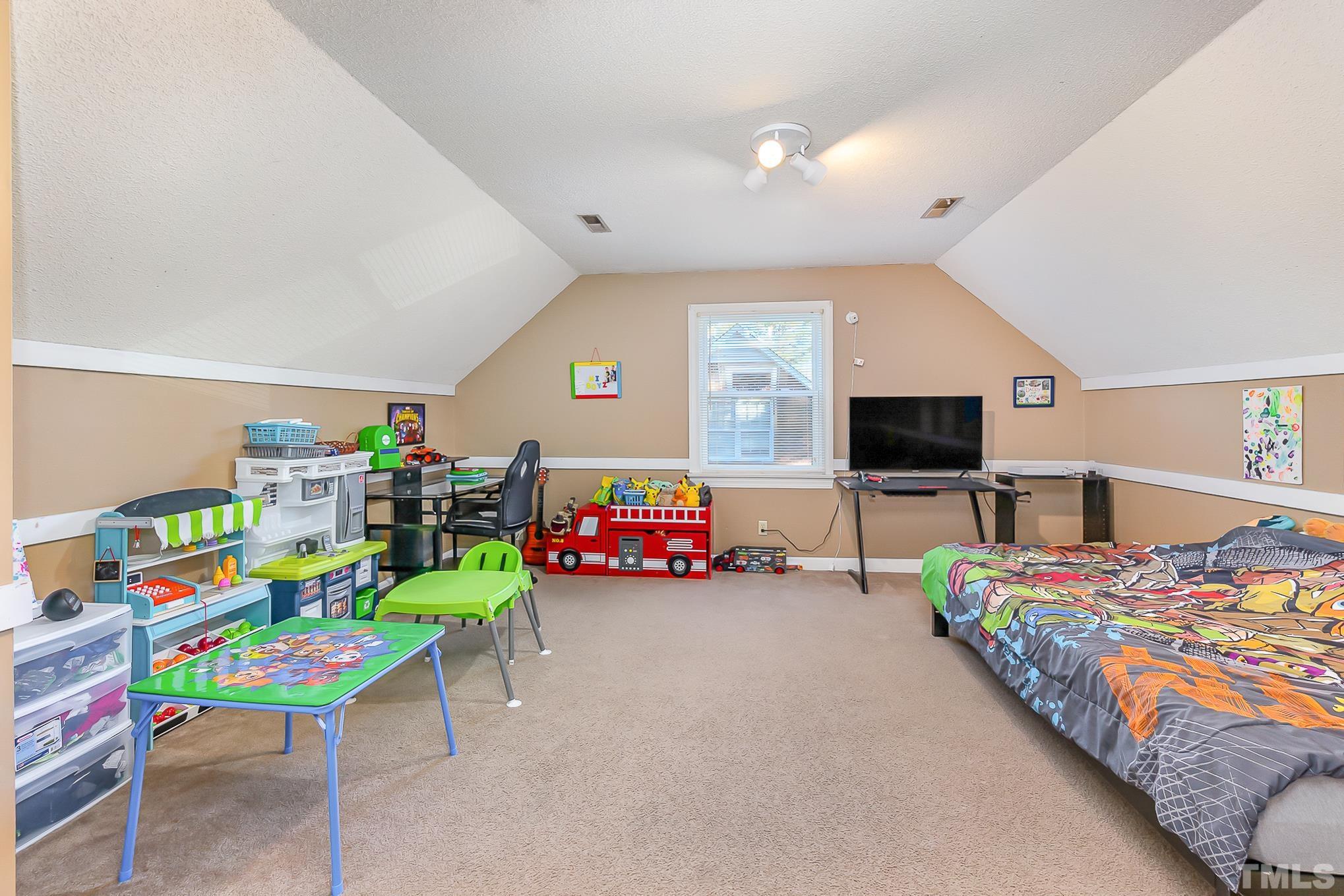 2904 Hodges Road Kinston, NC 28504 - Photo 20 of 29 a children room with toys and a flat screen tv