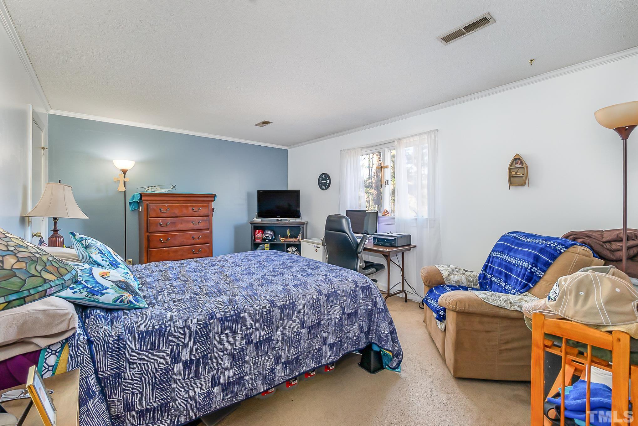 2904 Hodges Road Kinston, NC 28504 - Photo 21 of 29 a bedroom with bed and a couch
