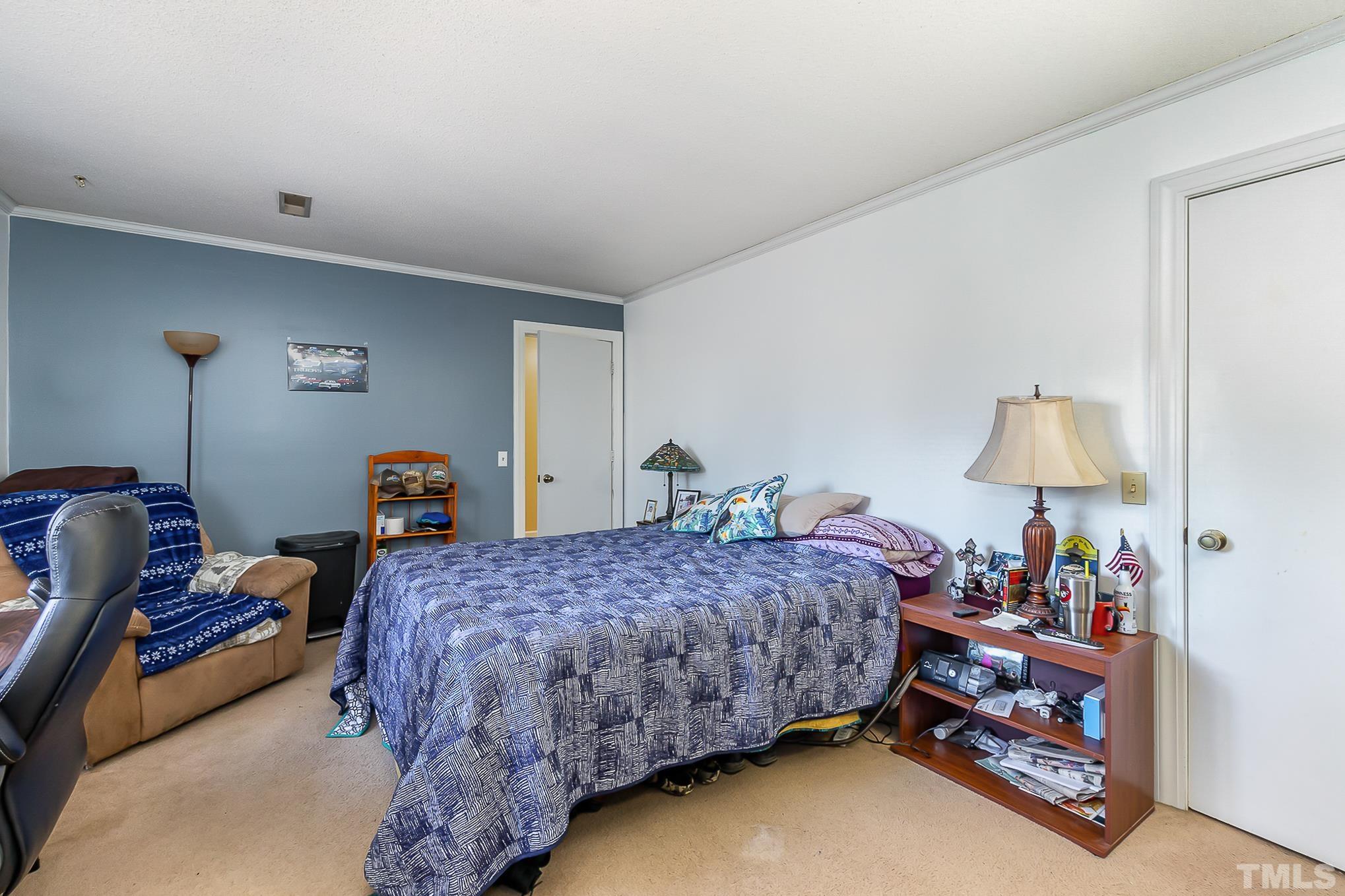 2904 Hodges Road Kinston, NC 28504 - Photo 22 of 29 a bedroom with a bed and a lamp