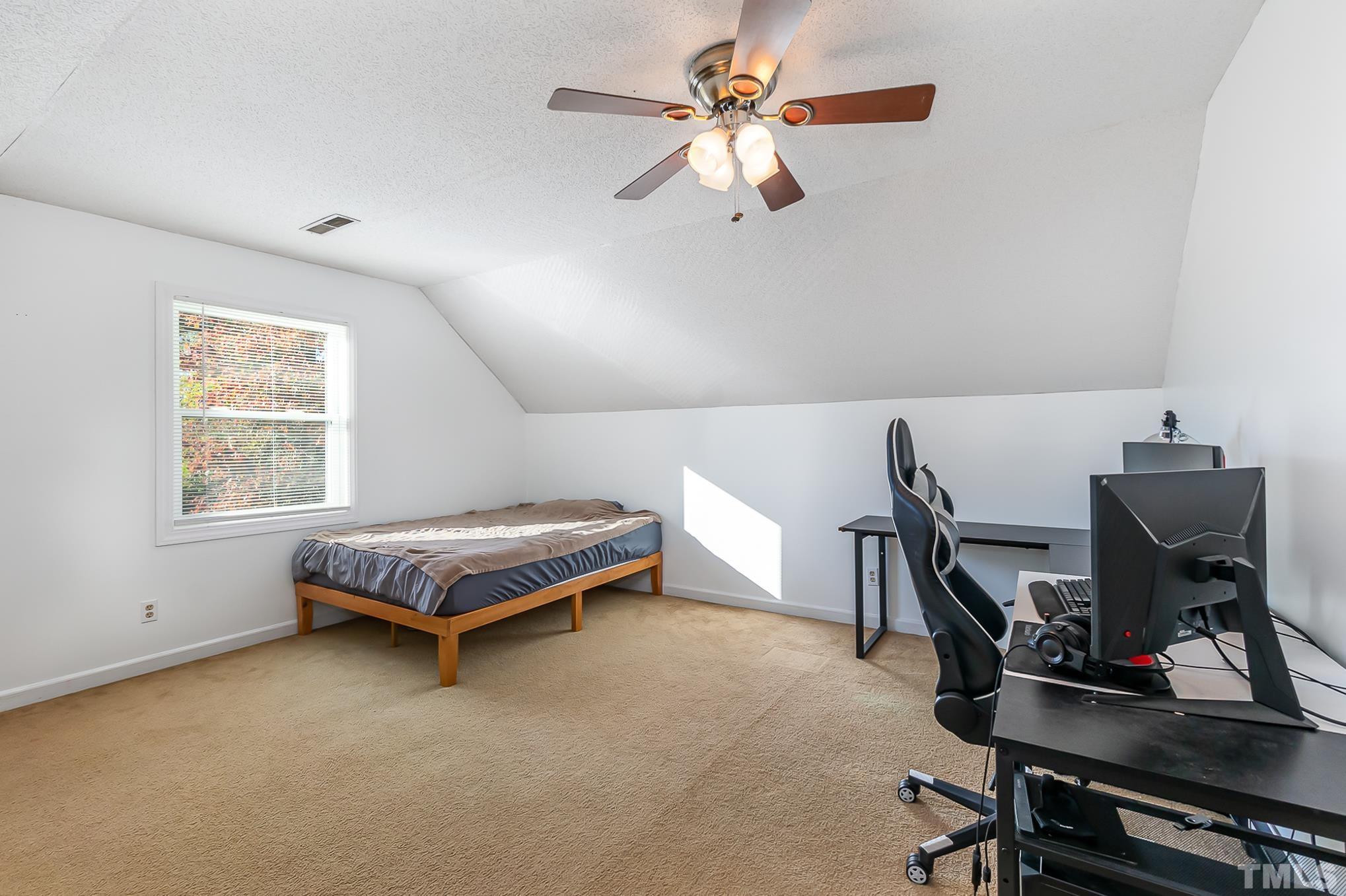 2904 Hodges Road Kinston, NC 28504 - Photo 24 of 29 a living room with a baby crib furniture a ceiling fan and a window