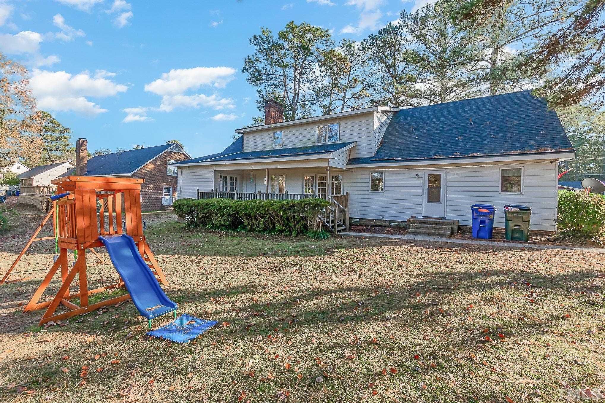 2904 Hodges Road Kinston, NC 28504 - Photo 28 of 29 a view of a house with a backyard and a tree