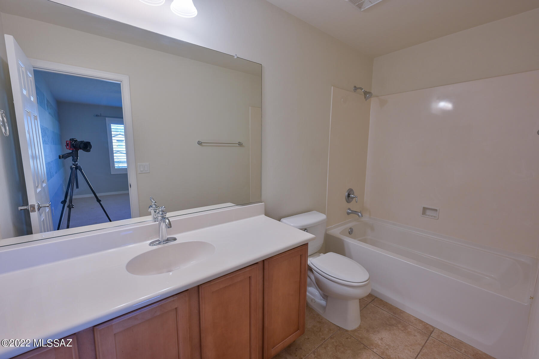 10804 East Salsabila Road Tucson, AZ 85747 - Photo 40 of 50 a bathroom with a sink a toilet and a large mirror