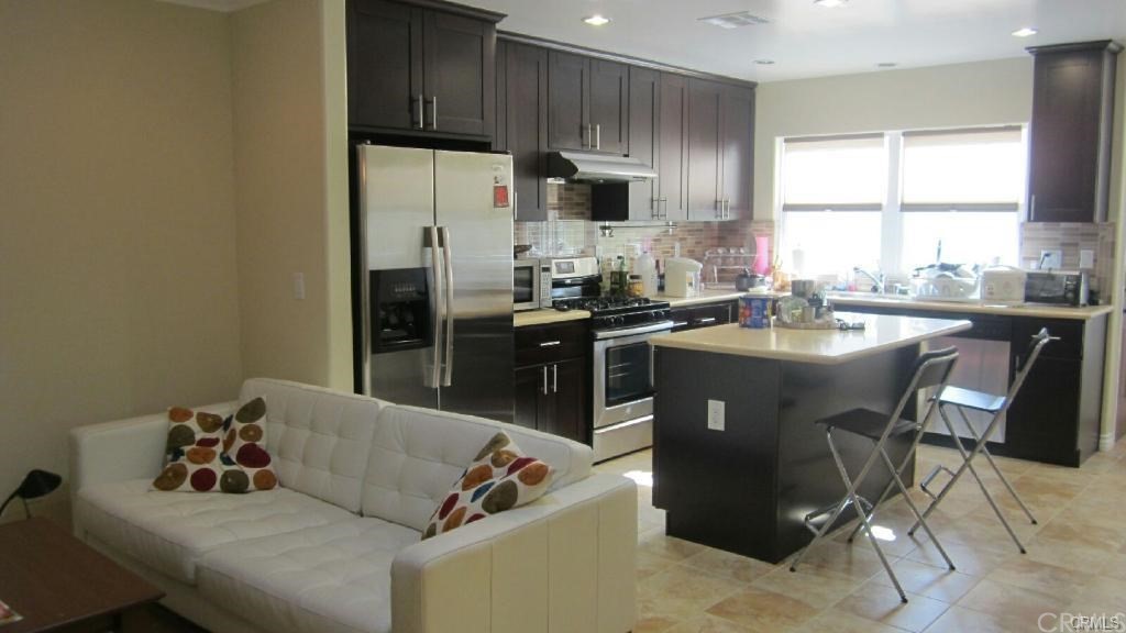 611 South Old Ranch Road Arcadia, CA 91007 - Photo 5 of 17 a kitchen with stainless steel appliances granite countertop a sink a stove a refrigerator and a cabinets