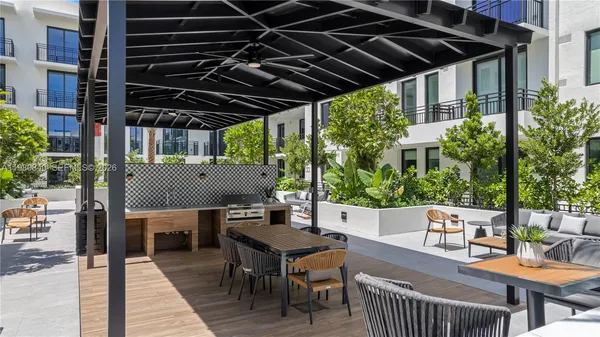 a swimming pool with outdoor seating and yard view