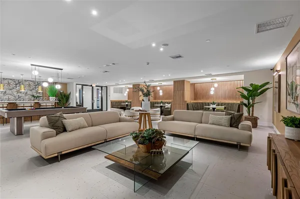 a living room with furniture and a chandelier