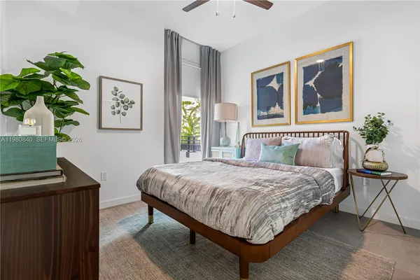 a bedroom with a bed wooden floor and window