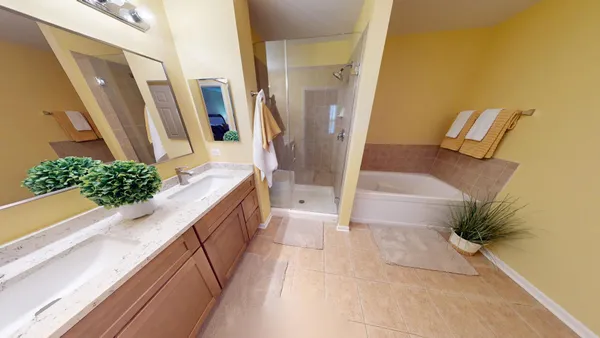 a bathroom with a tub sink and mirror
