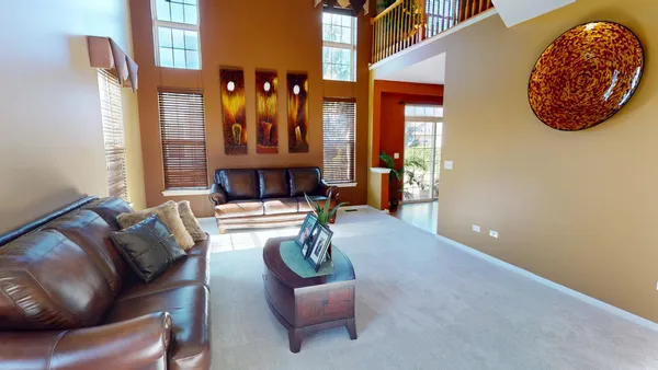 a living room with furniture and chandelier