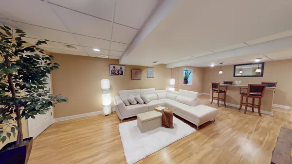 a living room with furniture and a potted plant