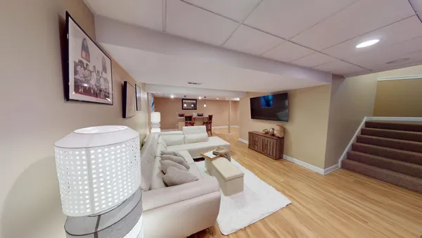 a living room with furniture a couch and a flat screen tv