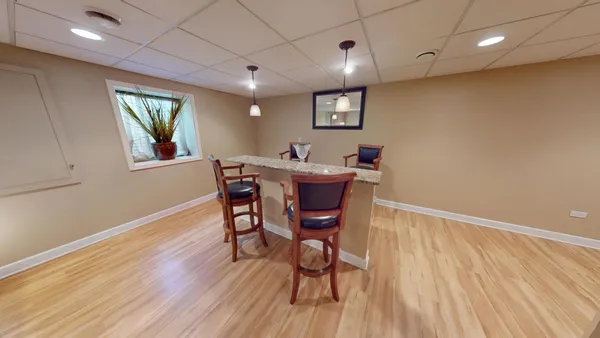 a view of a dining room with furniture and wooden floor