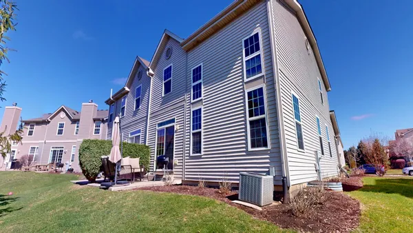 a view of a house with a backyard