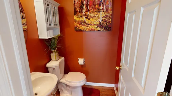a white toilet sitting next to a small bathroom