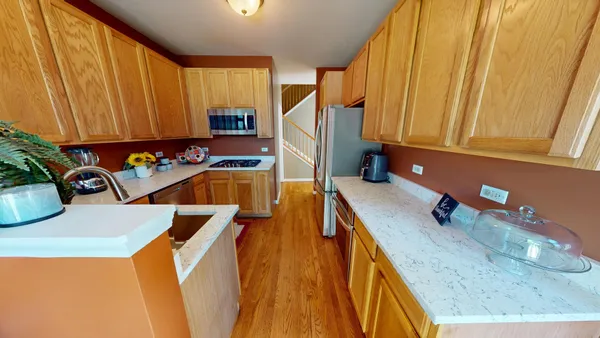 a kitchen with a sink a stove and a microwave