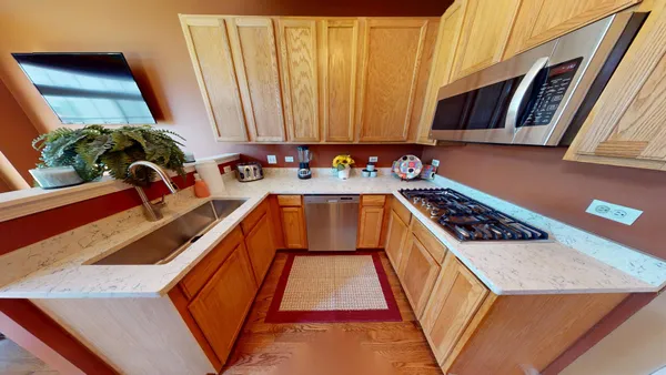 a view of a kitchen with a sink and cabinets